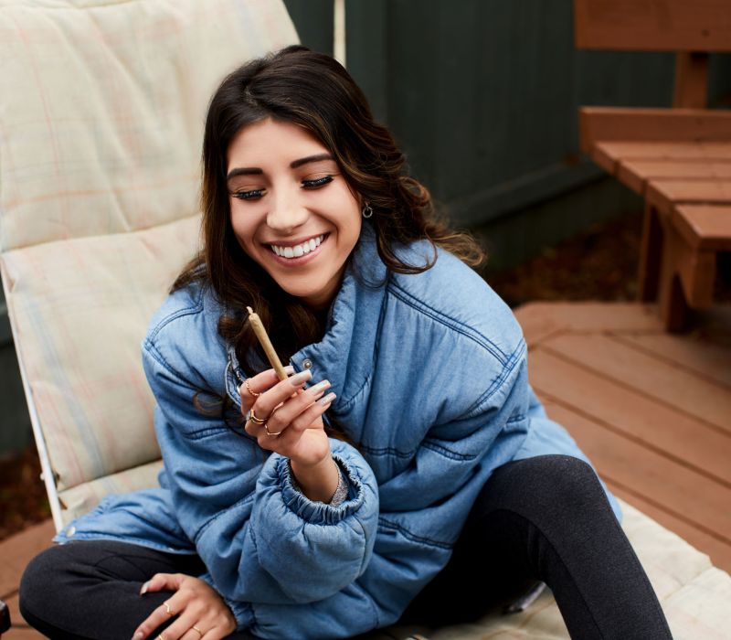 woman holding a joint, cannabis deals, pre-roll delivery